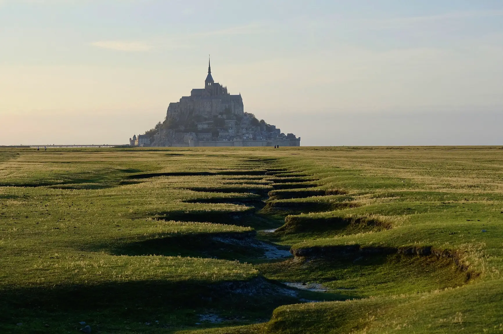 Mont Saint-Michel rising above the salt meadows at dusk
